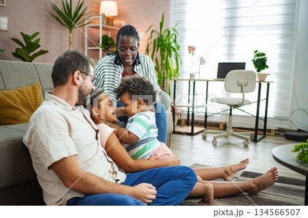 Laughter and bonding among family members in a warm room 134566507