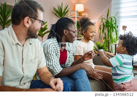 Family bonding moment in a cozy living room setting 134566512