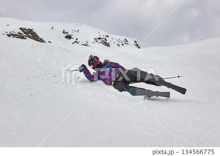 Skiing in the winter woman fallen over 134566775