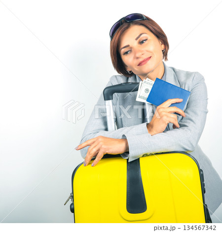 Happy beautiful business woman with passport and baggage going on a trip Happy beautiful business woman with passport and baggage going on a trip 134567342