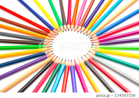 Multicolored pencils arranged in a circular pattern against a white backdrop 134567356