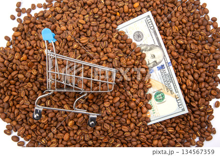 financial concept image featuring a tiny shopping cart, coffee beans financial concept image featuring a tiny shopping cart, coffee beans 134567359