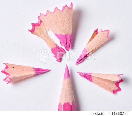 Wooden shavings and pink pencil on white background, top view Wooden shavings and pink pencil on white background, top view 134568232