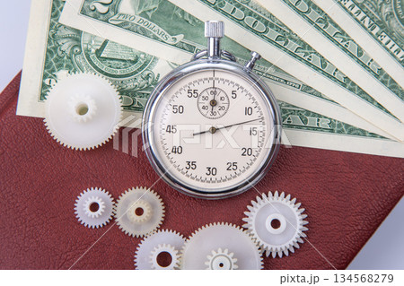 mechanical stopwatch on the background of dollars. Part time accuracy for business mechanical stopwatch on the background of dollars. Part time accuracy for business 134568279