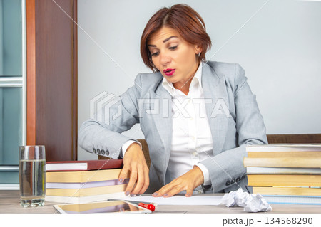 Business woman tired in the office and worried in emotions. Stress and headache Business woman tired in the office and worried in emotions. Stress and headache 134568290