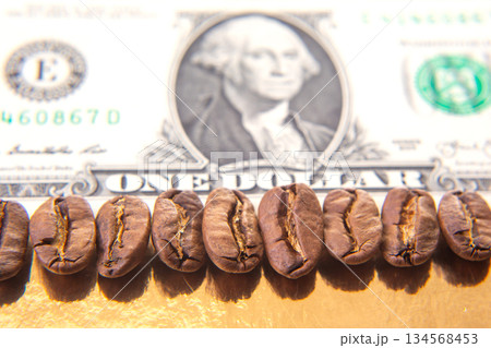 Macro shot of roasted coffee beans resting on a U.S. dollar bill 134568453