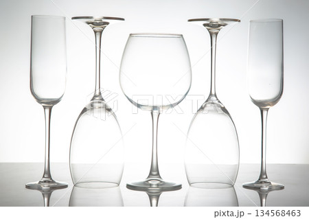 A sleek lineup of five elegant, empty wine glasses with long stems A sleek lineup of five elegant, empty wine glasses with long stems 134568463