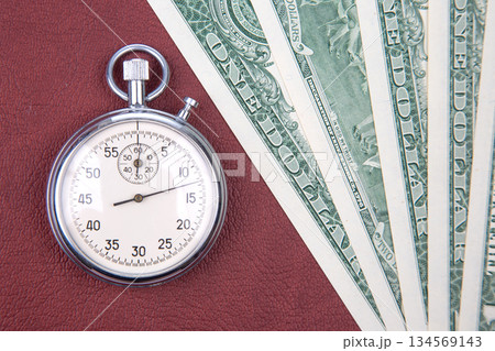 mechanical stopwatch on the background of dollars. Part time accuracy for business 134569143