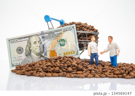 Artistic stock image of tiny figures near a pile of coffee beans, a cart with beans, and a 100 bill Artistic stock image of tiny figures near a pile of coffee beans, a cart with beans, and a 100 bill 134569147