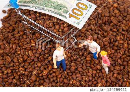 A whimsical stock photo showing miniature figures surrounded by coffee beans 134569431