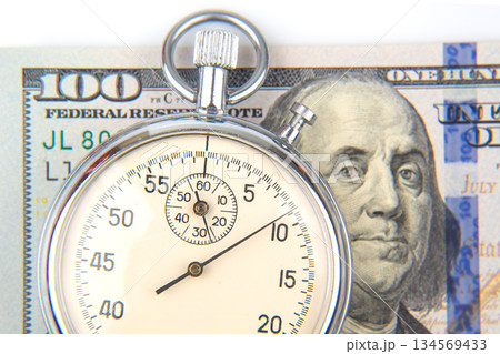 mechanical stopwatch on the background of dollars. Part time accuracy for business 134569433