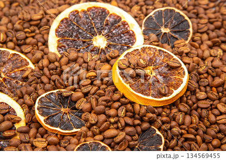 Warm and inviting image of dried citrus slices mingled with roasted coffee beans Warm and inviting image of dried citrus slices mingled with roasted coffee beans 134569455