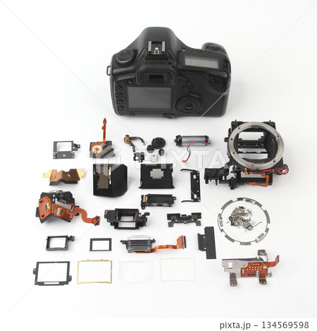Disassembled camera components laid out on a surface in a workshop setting Disassembled camera components laid out on a surface in a workshop setting 134569598