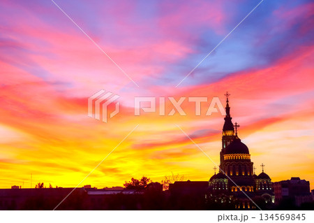 Sunset view over church silhouette with colorful sky in urban landscape 134569845
