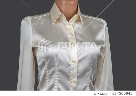 Elegant satin blouse on display with detailed buttons and a smooth finish 134569949