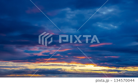 Stunning sunset over the Icelandic horizon with vibrant colors and dramatic clouds 134570044