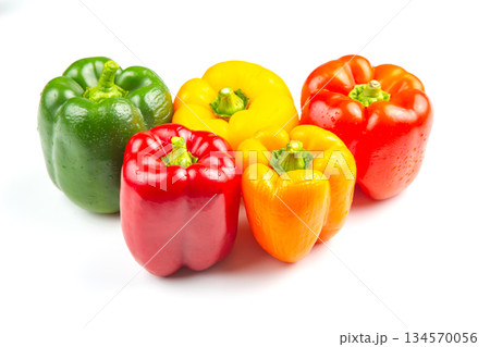 Colorful assortment of bell peppers on white background showcasing vibrant shades 134570056