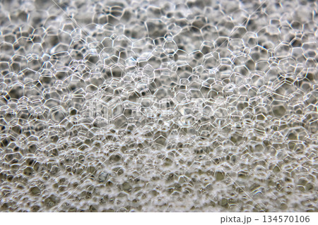 Close-up view of intricate soap bubbles forming a stunning hexagonal pattern 134570106
