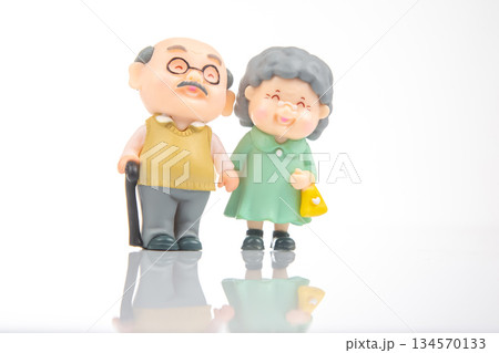 Miniature elderly couple walking together in a bright, cheerful environment Miniature elderly couple walking together in a bright, cheerful environment 134570133