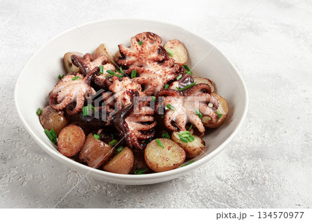 baby grilled octopus with golden baked potatoes and fresh herbs, Maltese cuisine, homemade, no people, 134570977