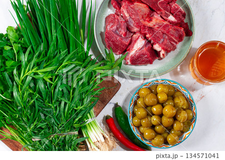 ingredients for cooking chakapuli, canned tkemali, meat, herbs Georgian cuisine, top view, 134571041