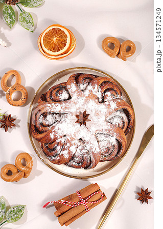 Homemade winter dessert, pie or cupcake with nuts, cinnamon, cranberries and poppy seeds, as well as egg liqueur.Festive kitchen banner. The concept of festive pastries, seasonal treats 134571249