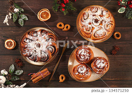 Homemade winter desserts, stollen, rolls, pies, or buns with nuts, cinnamon, cranberries, poppy seeds, and egg liqueur. Festive kitchen banner. Concept for holiday baking, seasonal treats, 134571250