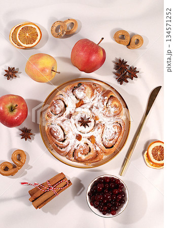 Apple pies and cupcakes with nuts, cinnamon, poppy seeds, cranberries, and egg liqueur.Homemade winter dessert,Festive kitchen banner. The concept of festive pastries, 134571252
