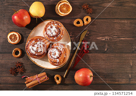 Buns or muffins with nuts, cinnamon, poppy seeds and apples, as well as egg liqueur.Festive kitchen banner. The concept of festive pastries, seasonal treats and cafe advertisements, restaurant menus 134571254