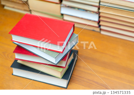 Stack of books in the library. Symbol of knowledge and learning. 134571335