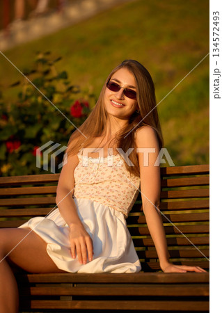 Slavic Woman in White Dress on Bench 134572493