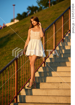 Slavic Woman in White Dress on Staircase 134572494