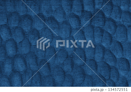 Blue painted wooden surface with carved texture pattern and natural wood grain background 134572551