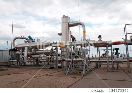 Pipes and caps for pipelines leading from oil and gas fields to storage tanks, energy self-sufficiency concept, global market forecast concept Pipes and caps for pipelines leading from oil and gas fields to storage tanks, energy self-sufficiency concept, global market forecast concept 134573542