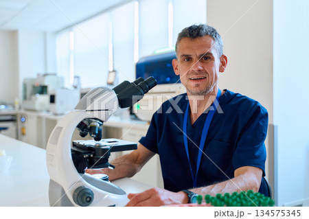 Scientist examining samples in modern laboratory with advanced equipment during working hours 134575345