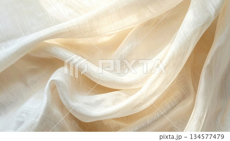 Luxury golden silk satin fabric background with smooth waves and elegant drapery texture creating a shiny soft material backdrop for decoration Luxury golden silk satin fabric background with smooth waves and elegant drapery texture creating a shiny soft material backdrop for decoration 134577479