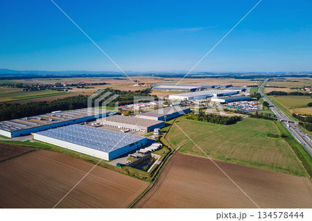 Aerial view of large logistics and warehouse complex in rural area 134578444