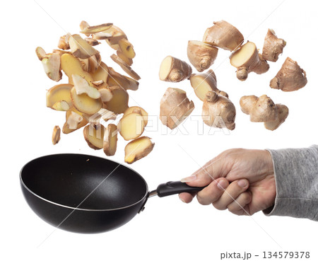 Galangal mix Ginger fall fly in pan, fresh vegetable spice ginger galangal falling. Organic fresh herbal ginger galangal root head cut chop slice. White background isolated freeze motion high speed Galangal mix Ginger fall fly in pan, fresh vegetable spice ginger galangal falling. Organic fresh herbal ginger galangal root head cut chop slice. White background isolated freeze motion high speed 134579378
