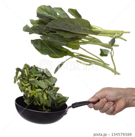 Kale fly fall in pan, green fresh vegetable chinese kale cut chop slice. Organic fresh vegetable with eaten leaf of chinese kale, heap close up texture. White background isolated freeze motion Kale fly fall in pan, green fresh vegetable chinese kale cut chop slice. Organic fresh vegetable with eaten leaf of chinese kale, heap close up texture. White background isolated freeze motion 134579389
