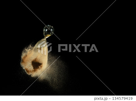 Hourglass fly in mid air, add more sand of time on gold sand over black background. Brown hourglass show more time Deadline extended time management hope concept hour glass, life clock passing by Hourglass fly in mid air, add more sand of time on gold sand over black background. Brown hourglass show more time Deadline extended time management hope concept hour glass, life clock passing by 134579419