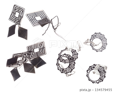 Fashion Silver Earrings with beautiful work detail is value. Luxury Silver diamond earring is fashion trend and fly in air. White background isolated 134579455