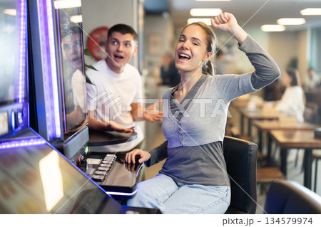 Young woman won at slot machine in cafe Young woman won at slot machine in cafe 134579974