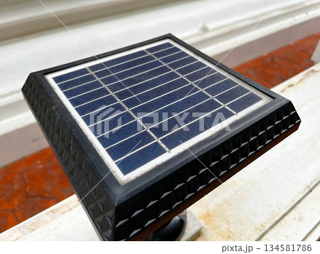 view of a small outdoor solar panel showcasing its textured black frame and clean grid cells, highlighting renewable energy technology in a simple, practical setting view of a small outdoor solar panel showcasing its textured black frame and clean grid cells, highlighting renewable energy technology in a simple, practical setting 134581786