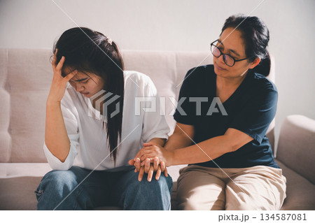 Moment of deep grief, sorrow and anxiety, lonely person overwhelmed by despair feels spark of hope when helping hand reaches out with genuine emotion to ease their problem. 134587081