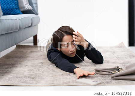 スマホを持って倒れる女性 スマホを持って倒れる女性 134587318