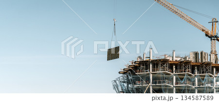 Construction of a building banner background. Construction site with crane. Business, development, industry. Construction of a building banner background. Construction site with crane. Business, development, industry. 134587589