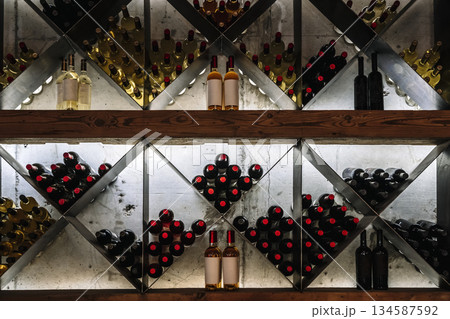 Modern Wine Cellar Display with Wooden Grid and Backlighting Modern Wine Cellar Display with Wooden Grid and Backlighting 134587592