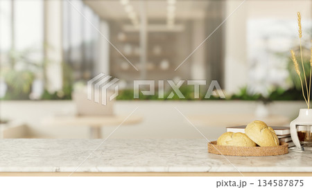 Bread on plate and coffee cup with books on marble counter across stool table and glass wall in cafe Bread on plate and coffee cup with books on marble counter across stool table and glass wall in cafe 134587875