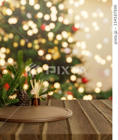 Pinecone and diffuser aside wooden tray at counter table across Christmas tree with light decoration 134587890