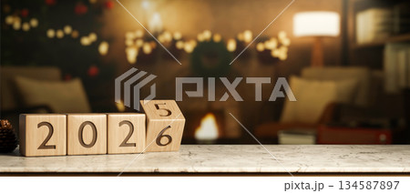 2026 new year countdown wooden block calendar on marble table across fireplace with Christmas decors 134587897